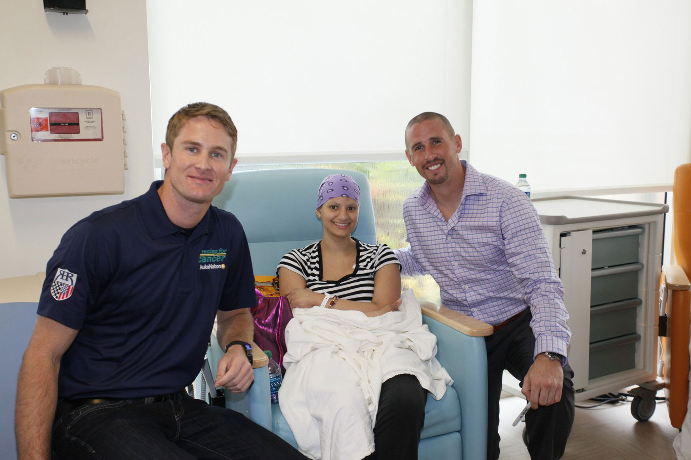 Indycar driver Ryan Hunter and Dolphins receiver Brian Hartline visited cancer patients to support the Dolphins Cycling Challenge.  October 24, 2013.  (Source: Miami Dolphins)
