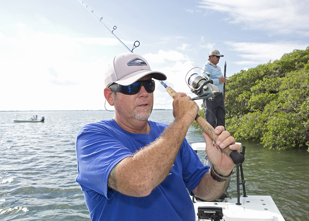Greg Poland, left,  casts a spinning rod with Captain Randy Towe while fishing in Everglades National Park Thursday, Oct. 17, 2013, near Islamorada, Fla. Thursday was the first day that Florida Keys guides and others could fish in the park's Florida Bay waters since a Washington budget impasse closed down much of the Federal government for 16 days.  (Bob Care/Florida Keys News Bureau)
