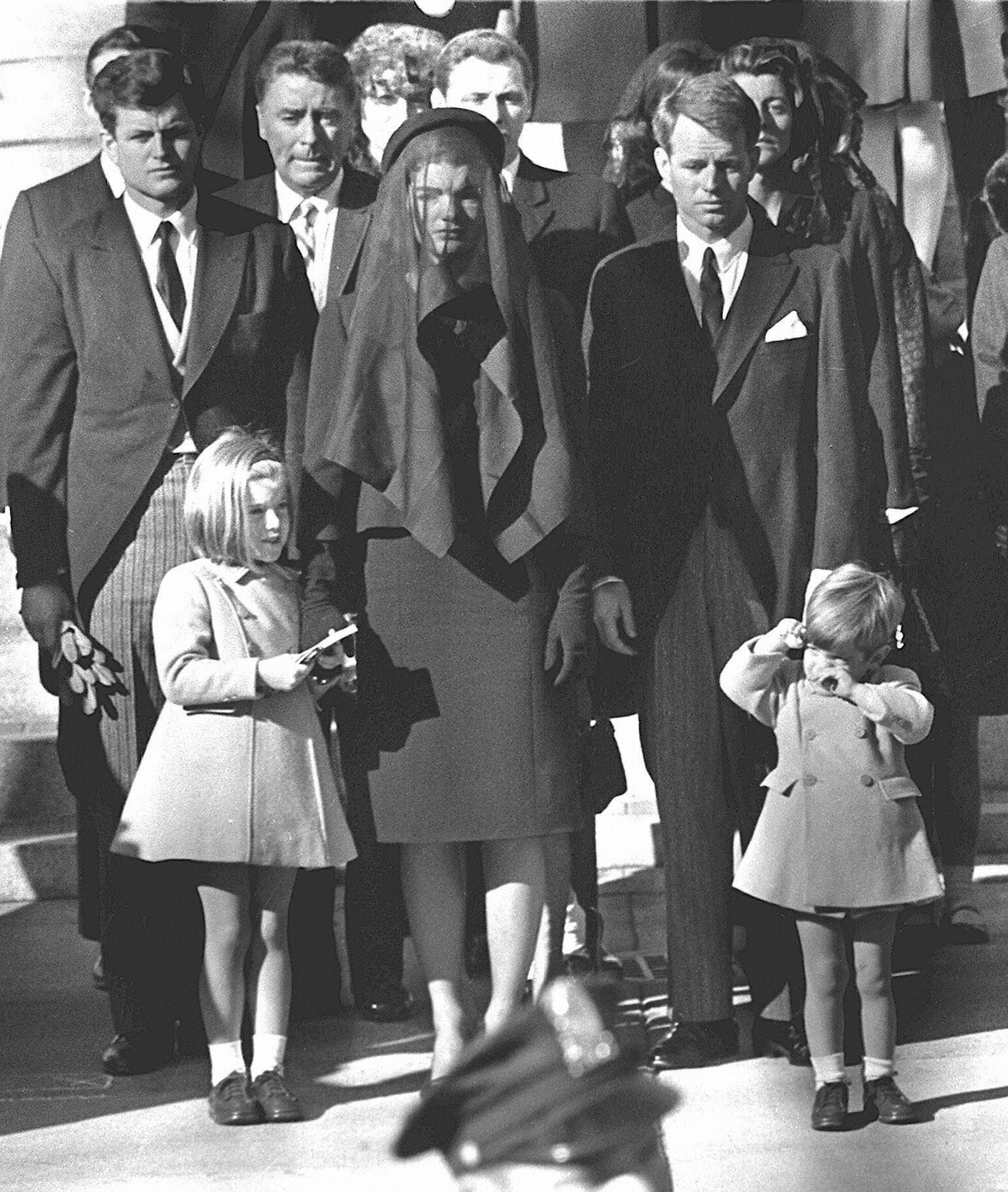 Jacqueline Kennedy(C) stands with her two children Caroline Kennedy(L) and John F. Kennedy, Jr.(R) and brothers-in law Ted Kennedy (L, back) and Robert Kennedy (2ndR) at the funeral of her husband US President John F. Kennedy 26 November 1963 in Washington, DC.  (Source: STAFF/AFP/Getty Images)
