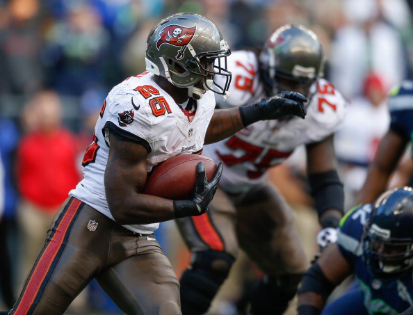 SEATTLE, WA - NOVEMBER 03:  Running back Mike James #25 of the Tampa Bay Buccaneers rushes against the Seattle Seahawks at CenturyLink Field on November 3, 2013 in Seattle, Washington. The Seahawks defeated the Buccaneers 27-24 in overtime.  (Photo by Otto Greule Jr/Getty Images)