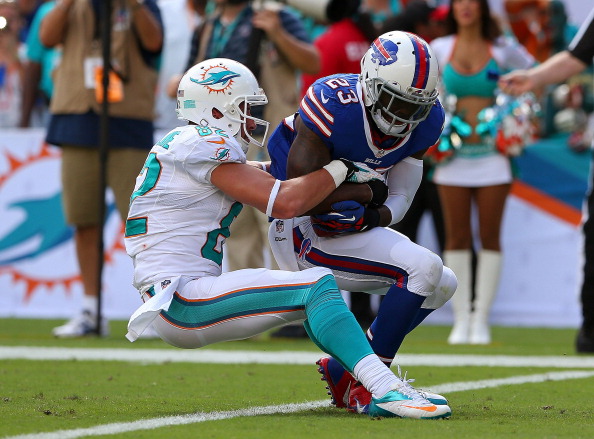 MIAMI GARDENS, FL - OCTOBER 20: Aaron Williams #23 of the Buffalo Bills makes an interception over Brian Hartline #82 of the Miami Dolphins  during a game  at Sun Life Stadium on October 20, 2013 in Miami Gardens, Florida.  (Photo by Mike Ehrmann/Getty Images)