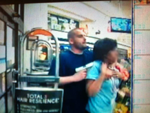 Man identified as Adrian Montesano holds woman at gunpoint during robbery at a Walgreens. Same man later killed in shootout with police. (Source: FOP)