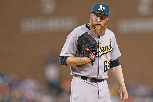 DETROIT, MI - JUNE 30: Sean Doolittle #61 of the Oakland Athletics looks in at home plate during the ninth inning of the game against the Detroit Tigers at Comerica Park on June 30, 2014 in Detroit, Michigan. The Tigers won the game on a walk off grand slam home run by Rajai Davis #20. The Tigers defeated the Athletics 5-4. 