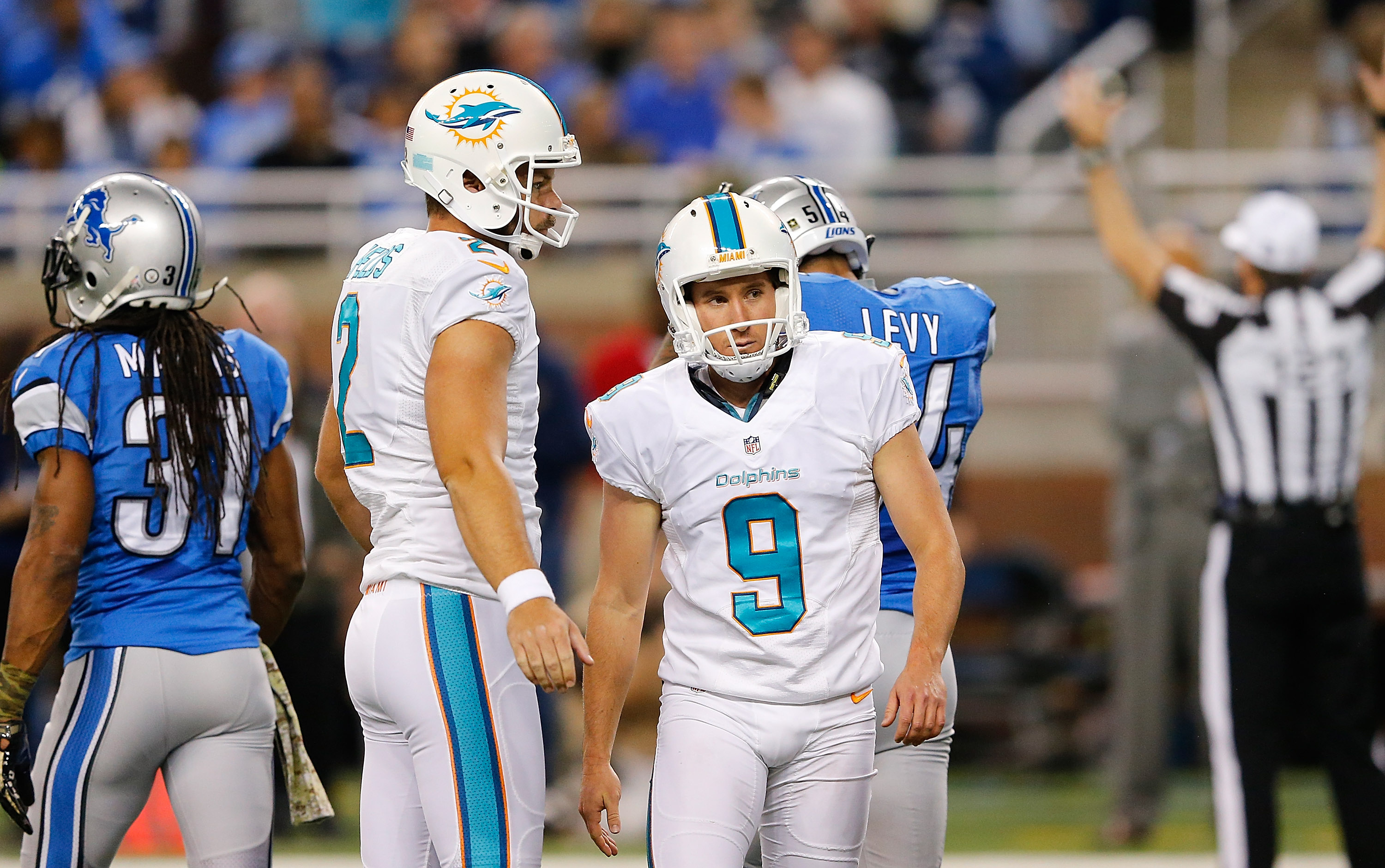 Caleb Sturgis #9 and Brandon Fields #2 of the Miami Dolphins walk off the field after kicking a second quarter field goal against the Detroit Lions at Ford Field on November 09 , 2014 in Detroit, Michigan. (Source: Leon Halip/Getty Images)