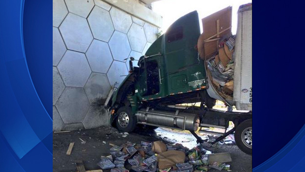 A semi-truck driver was rushed to the hospital after slamming into a wall in Weston on March 12, 2015. (Source: BSO) 