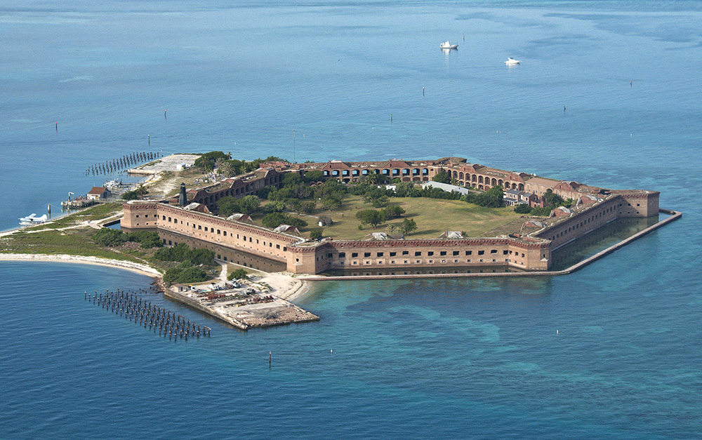 This aerial photo shows Fort Jefferson in Dry Tortugas National Park Friday, July 24, 2015. The former Union military prison's most famous prisoner was Dr. Samuel A. Mudd, who was imprisoned for four year after being convicted of conspiring with John Wilkes Booth to assassinate President Abraham Lincoln. On Friday, about 80 of Mudd's descendants made the pilgrimage to the isolated Gulf of Mexico fort  that lies 68 miles west of Key West, Fla., to mark the 150th anniversary of Mudd's July 24, 1865, arrival. Although he was pardoned and released some four years later, family efforts to have his conviction expunged have failed. (Andy Newman/Florida Keys News Bureau/HO)