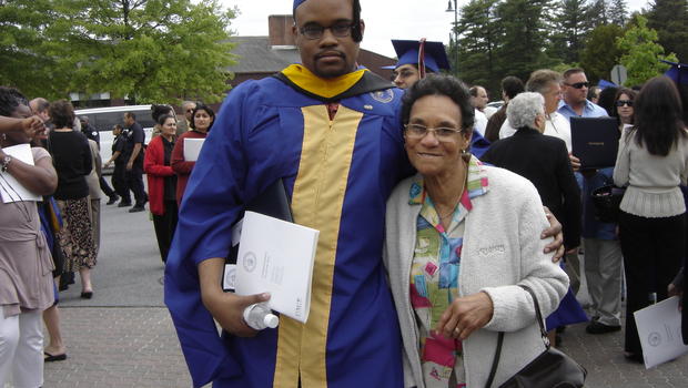 In this undated photo provided by Jennifer Young, Jermaine McBean, left, with his grandmother Sylvia McDonald pose for a photo at Jermaine's graduation from Pace University. Jermaine McBean was shot by a sheriff's deputy while carrying an air rifle in 2013. (Source: AP)