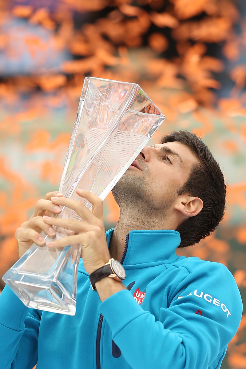 Novak Djokovic of Serbia celebrates with the Butch Buchholz trophy after defeating Kei Nishikori of Japan during the final on Day 14 of the Miami Open presented by Itau at Crandon Park Tennis Center on April 3, 2016 in Key Biscayne, Florida. (Photo by Matthew Stockman/Getty Images)