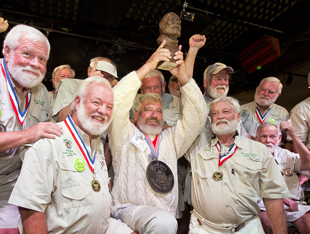 Dave Hemingway, center, hoists his trophy after winning the 2016 Ernest 