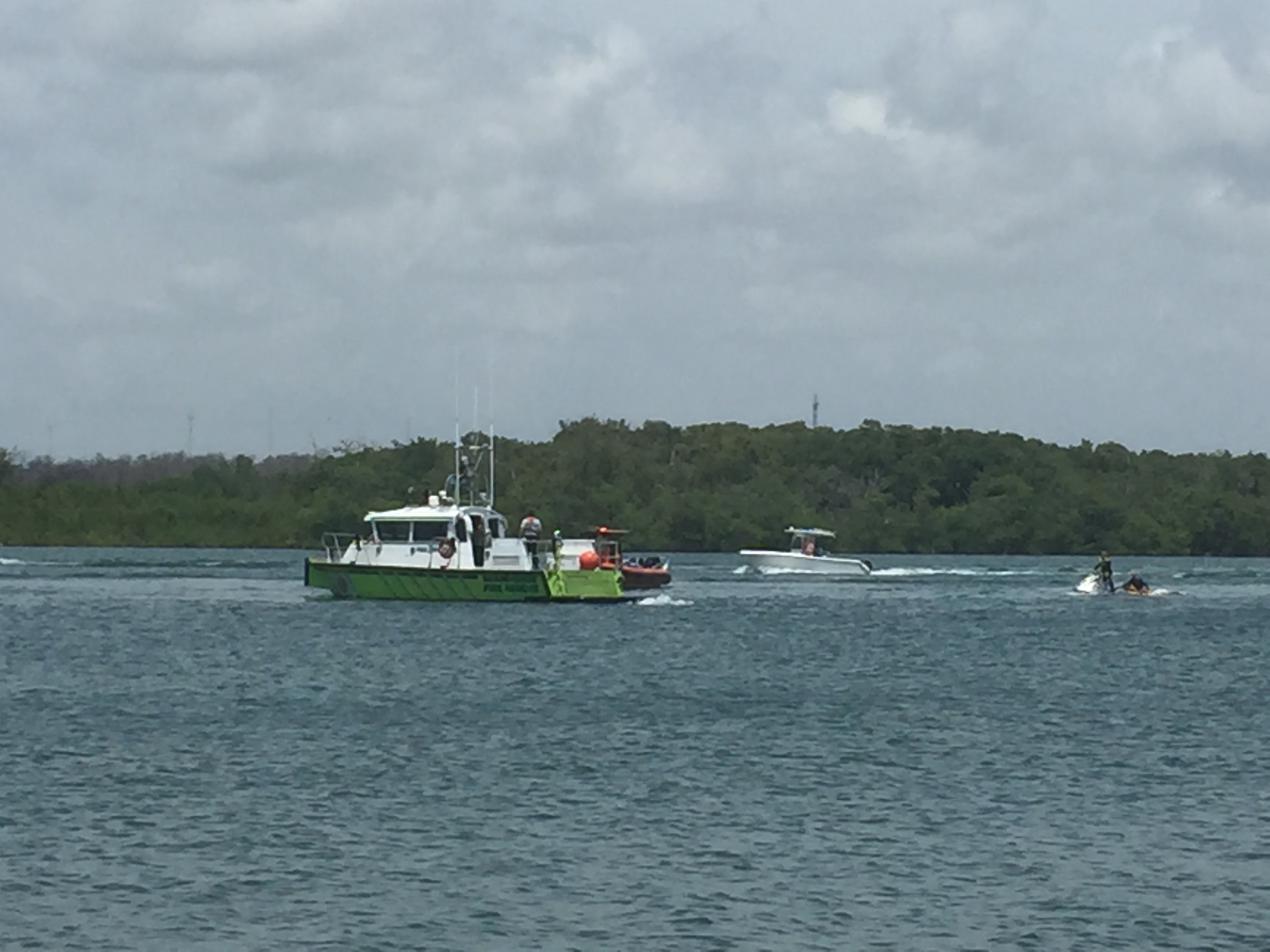 Rescue crews arrive to save 4 people on board a boat that capsized on August 6, 2016. (Courtesy: Miami-Dade Fire Rescue) 