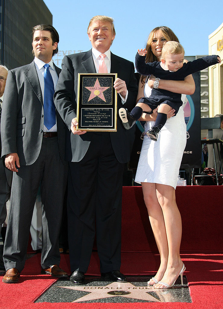 U.S. billionaire Donald Trump, the producer of NBC's The Apprentice, poses with his family, his son Donald Jr. (L), his wife Melania and their son Barron (R) after he was honored with the 2,327th star on the Hollywood Walk of Fame on Hollywood Boulevard in Hollywood, CA, 16 January 2007. (Photo by GABRIEL BOUYS/AFP/Getty Images)