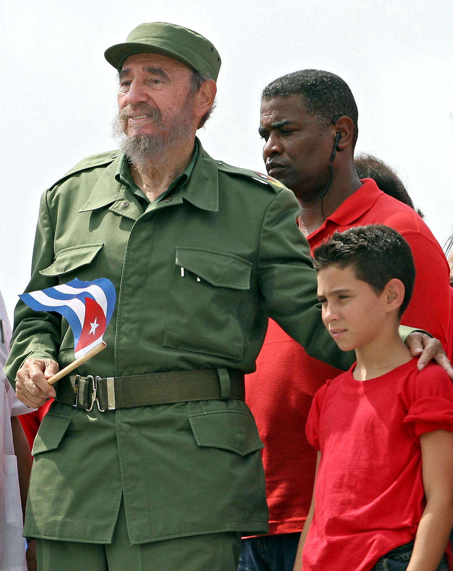 Cuban President Fidel Castro (L) poses with shipwreck survivor Elian Gonzalez, after presiding over a massive May Day demonstration at Havana's Plaza de la Revolucion, 01 May 2005. (ADALBERTO ROQUE/AFP/Getty Images)
