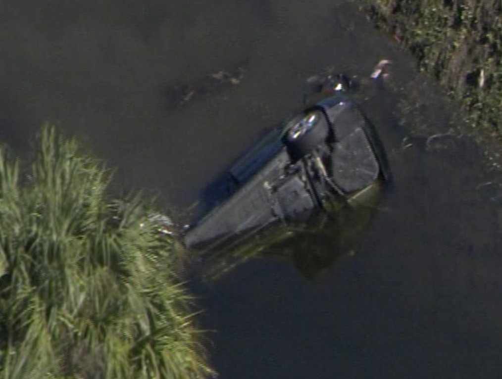 A car was seen overturned in a canal off I-95 in Deerfield Beach on Dec. 23, 2016. (Source: CBS4)